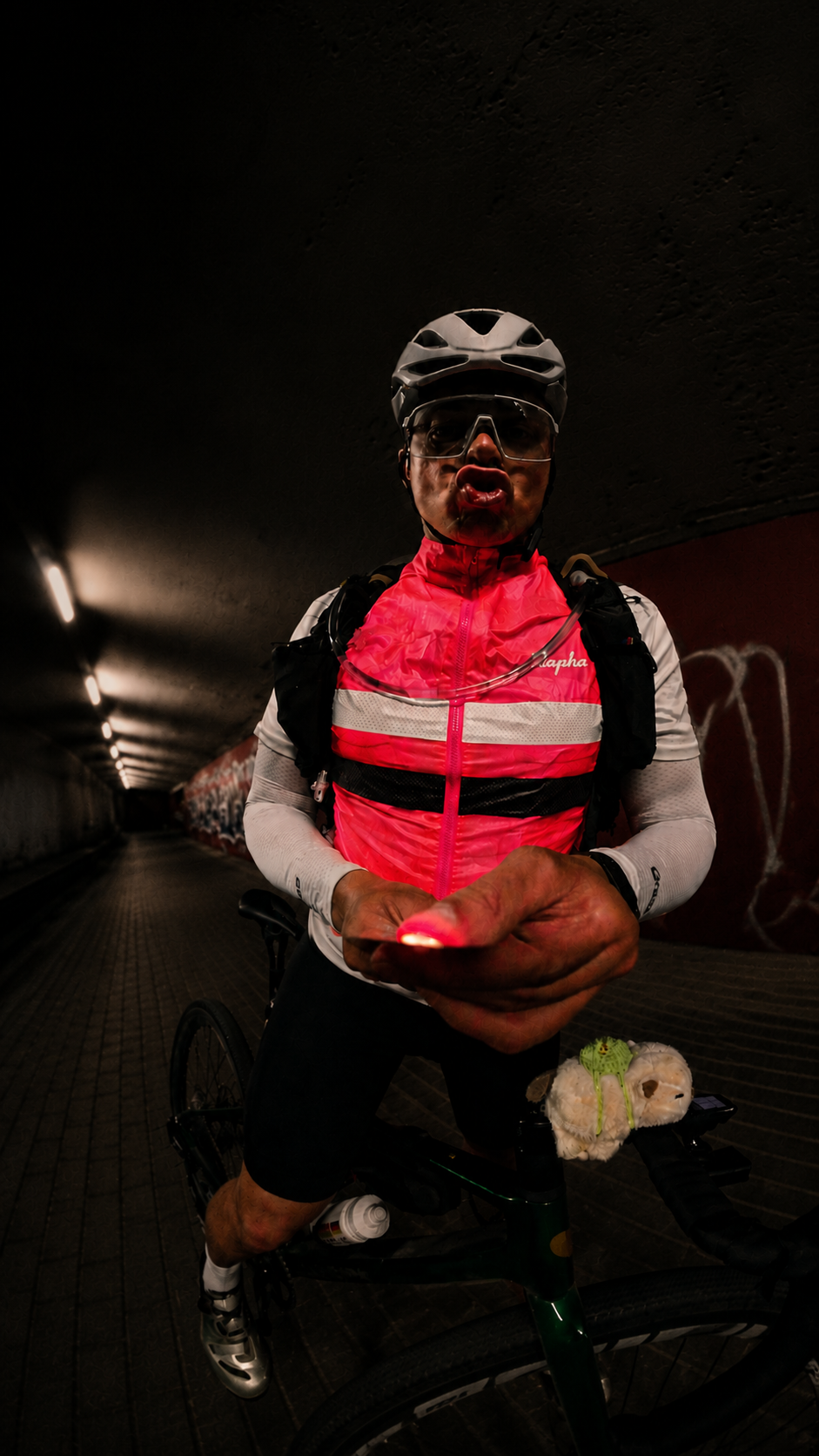 Cyclist stopped in a dark tunnel during a night ride